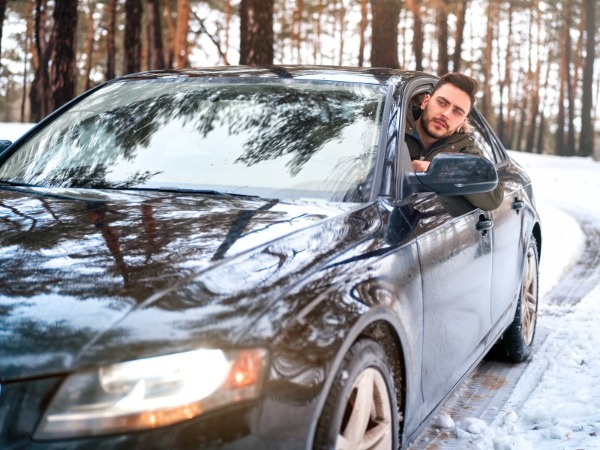 Man Driving in a Snowy Road